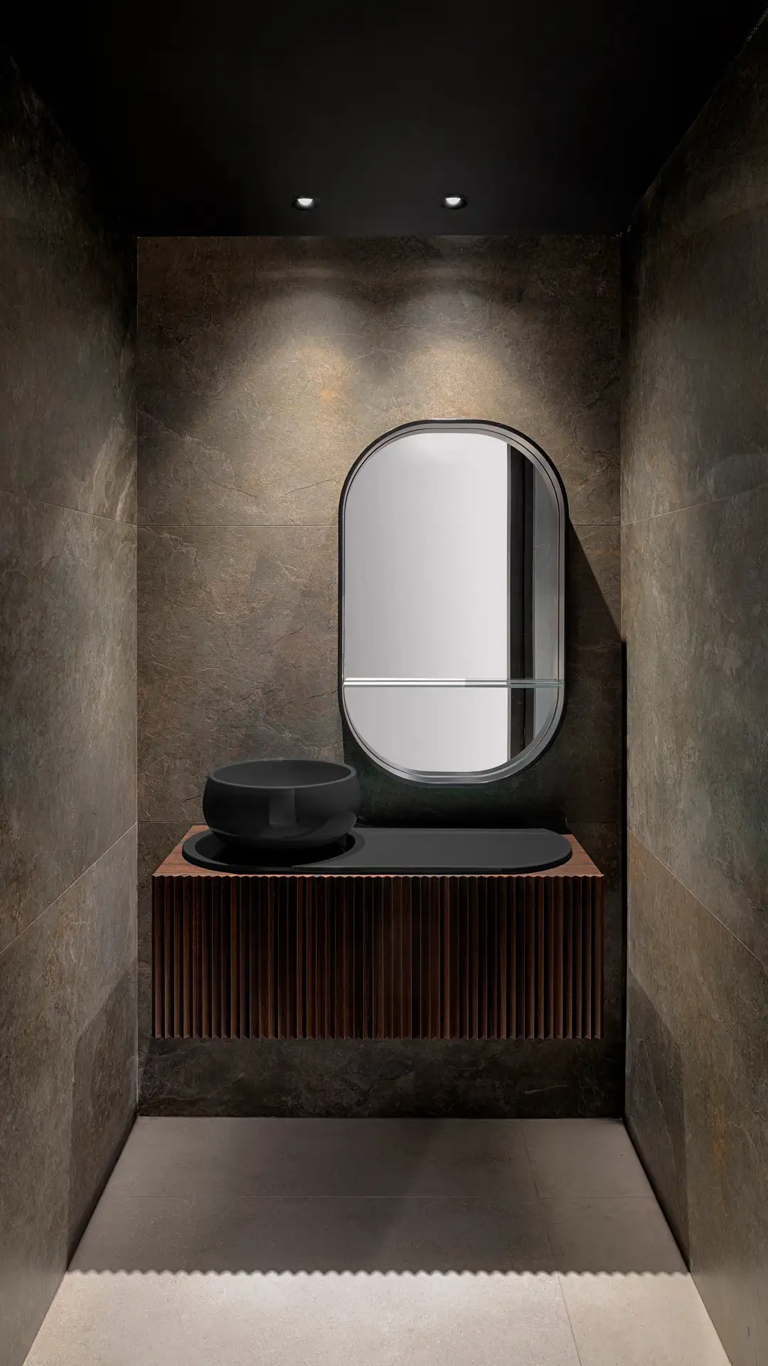Blick in eine Badezimmernische mit dunkelgrauen Wänden. Kleine Lichtspots an der Decke beleuchten Spiegel und Waschtisch